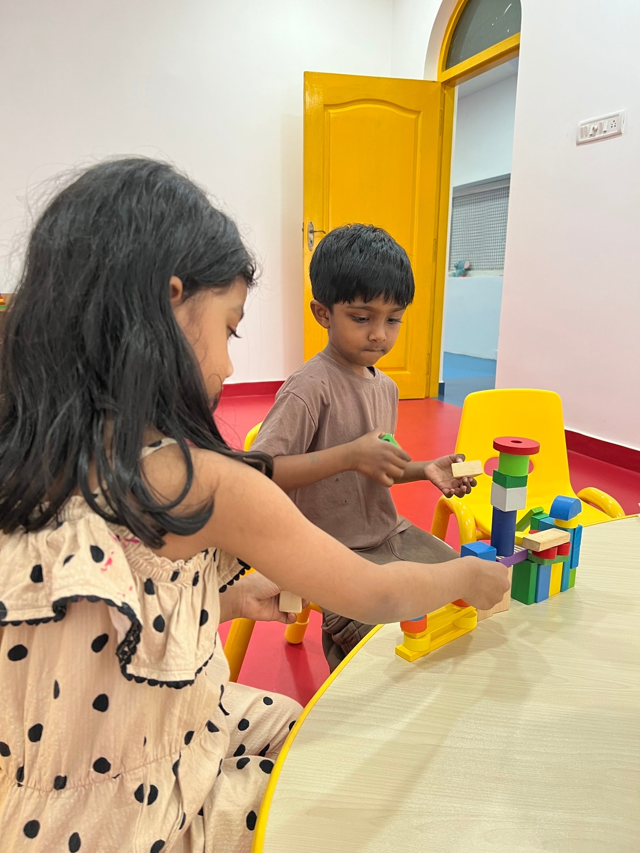 Children building with colorful blocks together