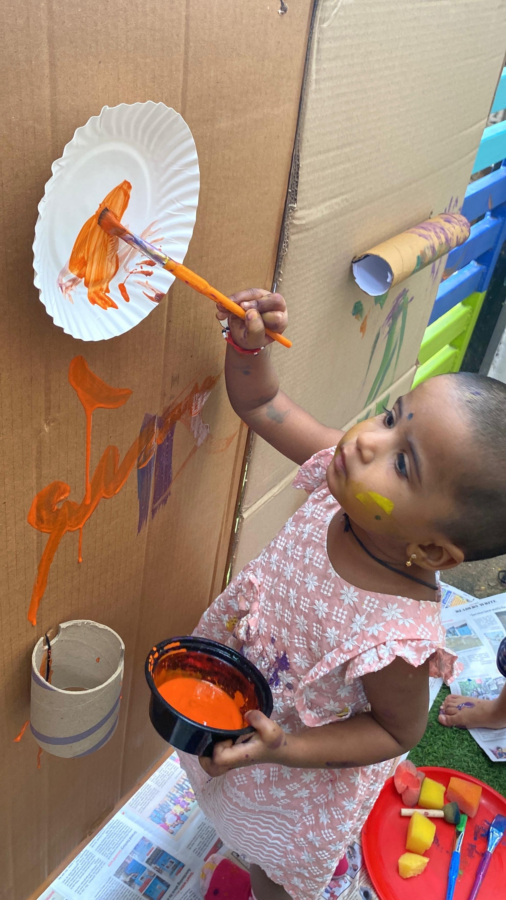 Child painting during art activity at Little Fliers